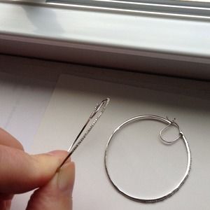 Silver hoop earrings with sparkle edging.