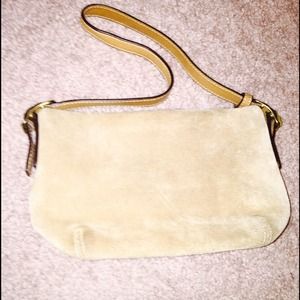 Small tan leather coach bag.