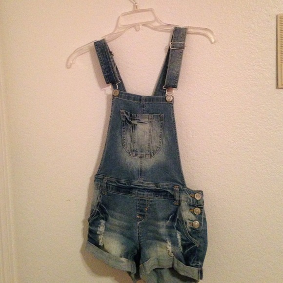 Distressed denim overall shorts.