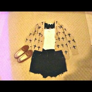 Tan sweater with black crosses.