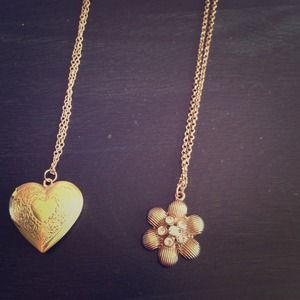 Two gold necklaces. Heart locket/golden flower