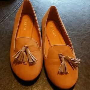 SARA Slip ons shoes they are tan with tassels
