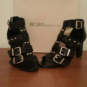 BCBGeneration Black and Gold Strappy Sandals