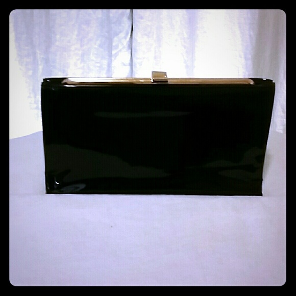 Black clutch with gold hinge clasping frame