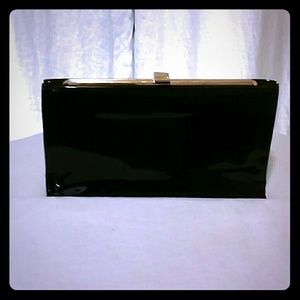 Black clutch with gold hinge clasping frame