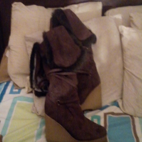 A pair of dark brown knee high boots