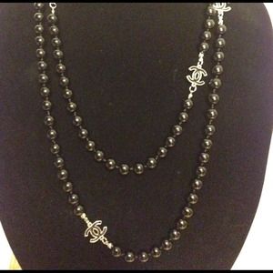 Black chanel long necklace.