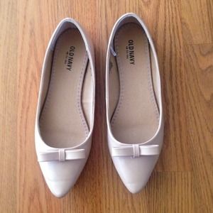 Bundled nude flats and pink skirt