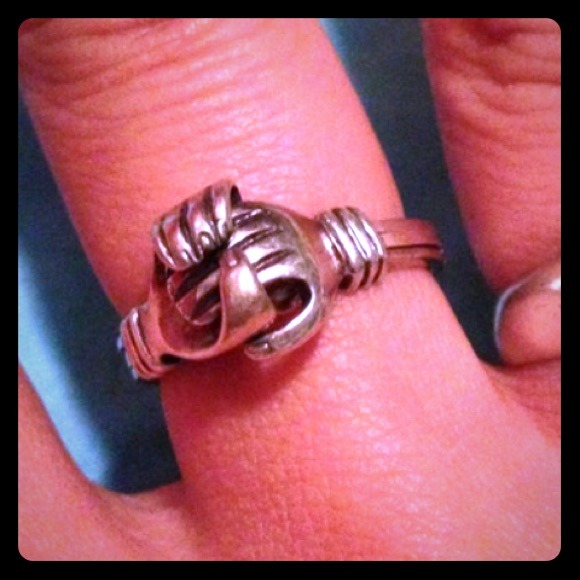 Hands holding heart ring