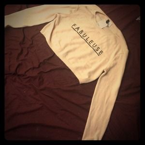 cropped light pink sweater.