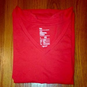 Orange V-neck Gap shirt.