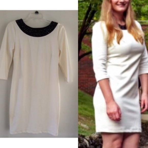 White dress with black embellished neckline