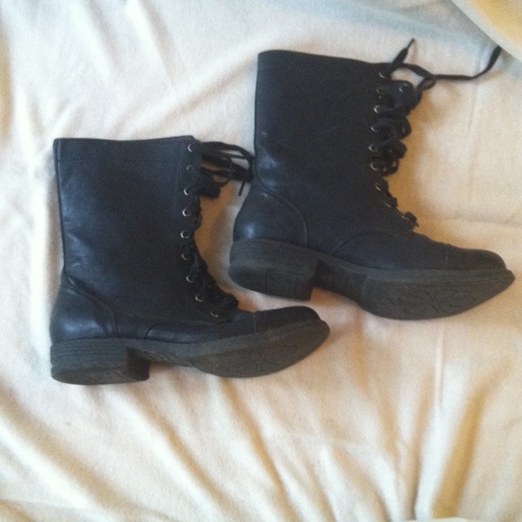 Black mid-calf lace-up boots.