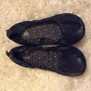 black ballet flats with zipper detail on back