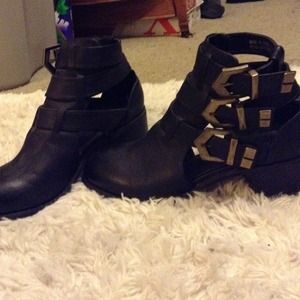 black boots with gold buckles