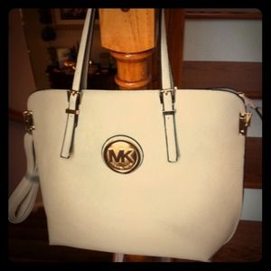 Large creme handbag with gold accents. NWOT.