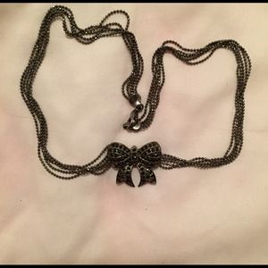 Black necklace with bow pendant