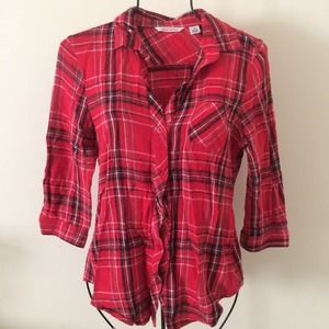 Red and black flannel form fitting shirt.