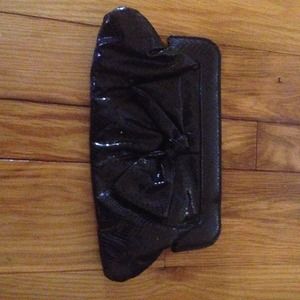 Black faux snack skin clutch.
