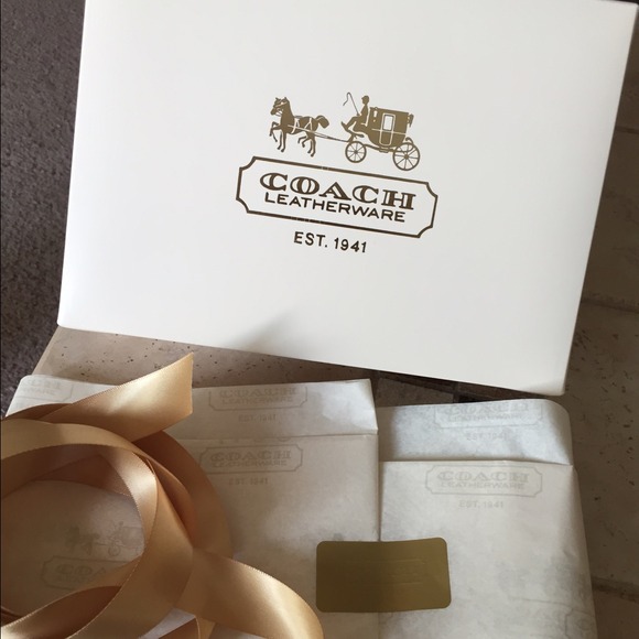 Coach box with tissue paper and gold bow