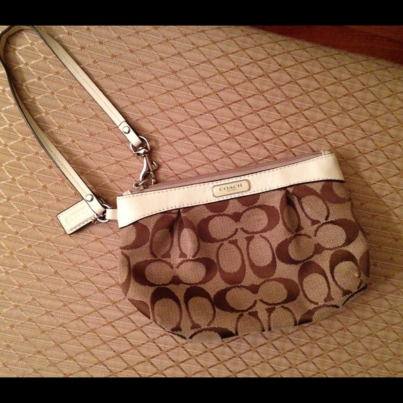 Brown and white Coach wristlet