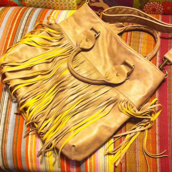Suede fringe on tan leather purse.