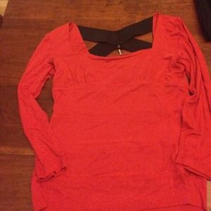 Long sleeved red shirt with black x in back.