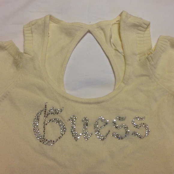 Cream colored Guess sweater with shoulder holes.