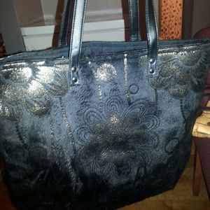Black and gold tote with zipper top.
