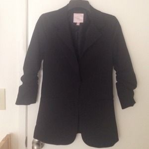 Black blazer with crinkled sleeves.