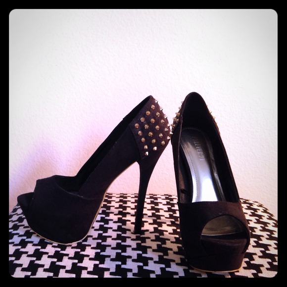 Studded, peep toe black and gold platforms.
