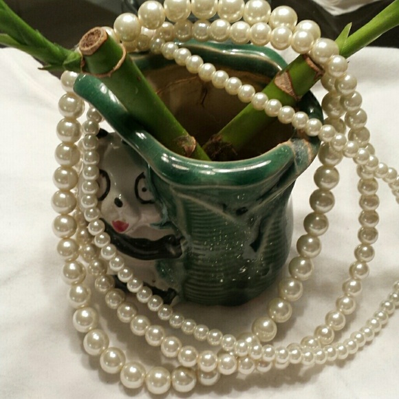 3 separate stands of faux pearls.