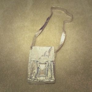 A sequin silver mini purse with Velcro secure