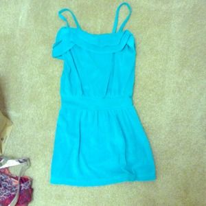 A turquoise bathing suit cover up