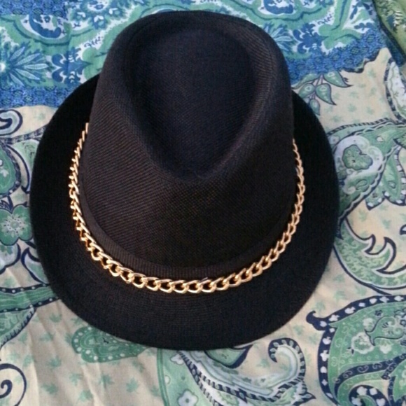 Black fedora with gold chain.