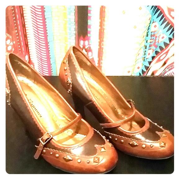Brown studded, strapped heals. 3' 1/2" heal.