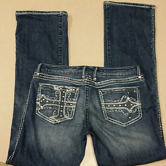 Lightly worn blue jeans with bling on the pockets