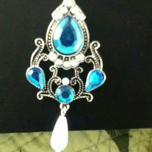 A necklace with a blue jeweled pendent