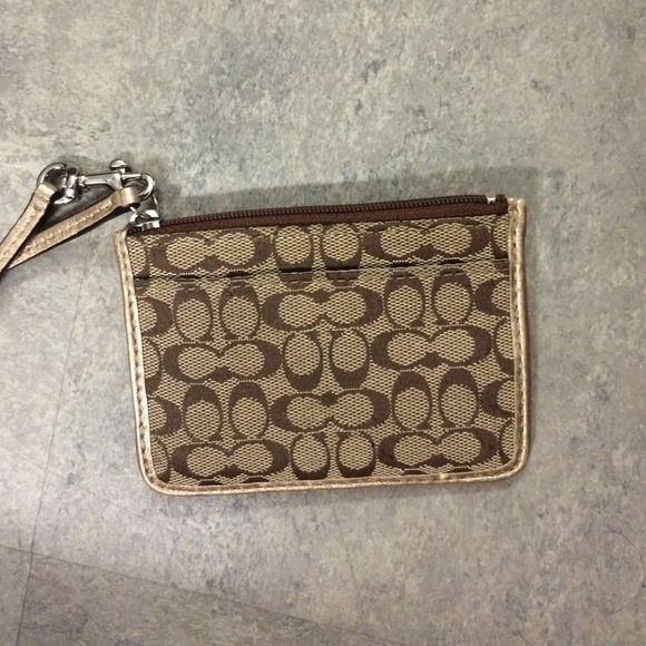 Small coach clutch. Can fit a few cards/Id/change