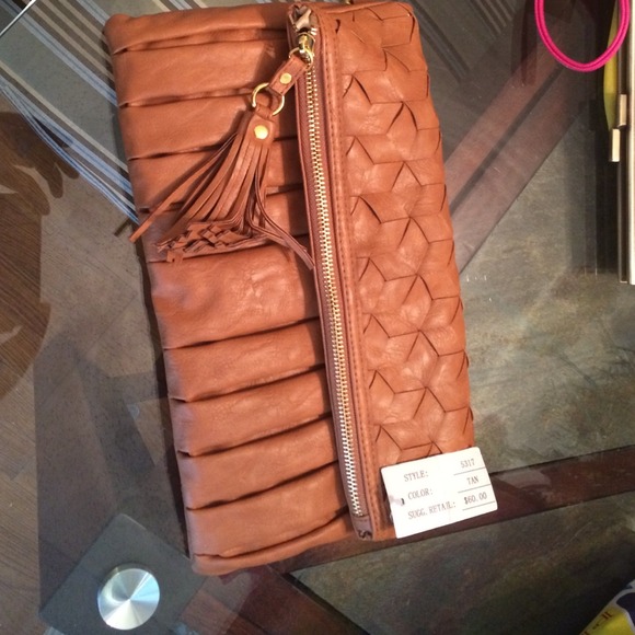 A stylish urban expression brown clutch.