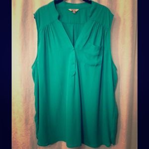 Green sleeveless blouse.