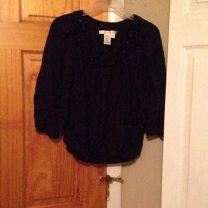 Black top with beading trim around the neck area