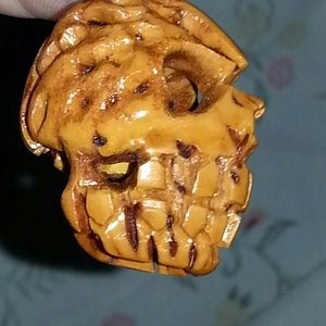 Handmade carved skull from a peach seed