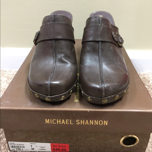 Brown studded clogs.