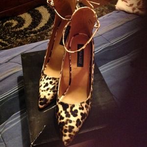Leopard  print heels with strap going around it.