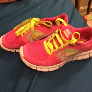 Hot pink and lime green Nike running shoes