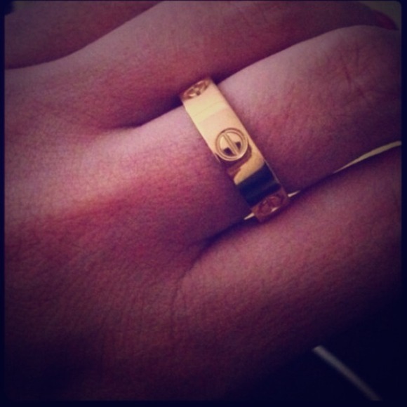 Gold tone love ring with "screws"