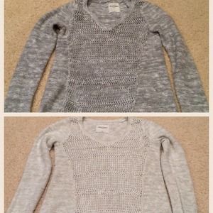 Two white and grey sparkly sweaters