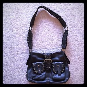 Edgy cross-body bag with hardware detail.