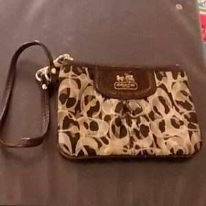 A cheetah print coach wristlet